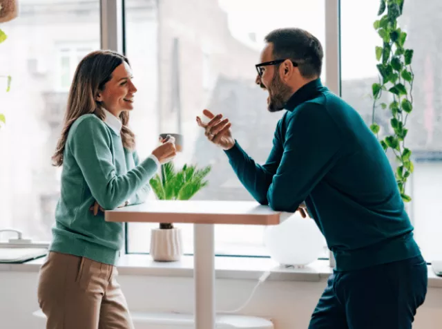 Cowerking talking at a table
